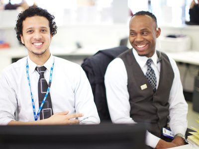 Two staff members at a reception desk