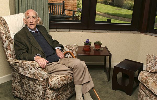 An older man sitting in a care home