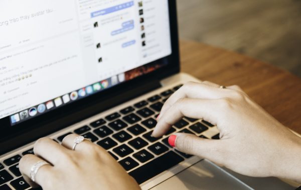 Close up photo of a womans hands typing