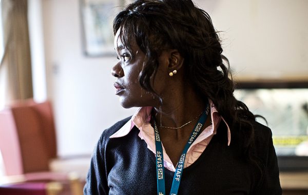 An NHS worker with a lanyard