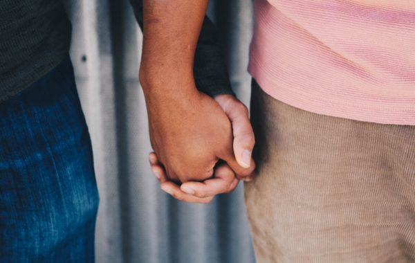 Two men holding hands