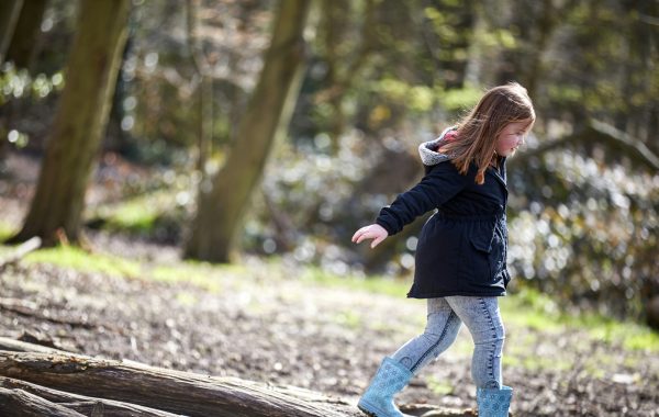 A young girl balances along a log. Image credit: World Obesity Federation