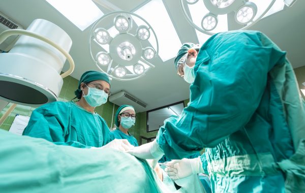 Surgeons with patient in operating theatre