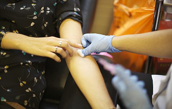 A woman is getting blood taken for a routine test