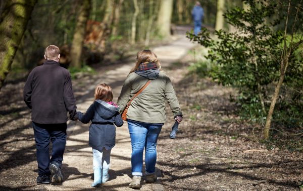 A family walking in the woods