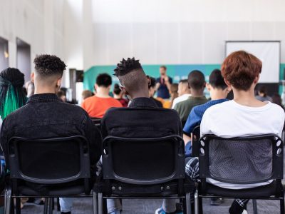 Students sitting on chairs in school