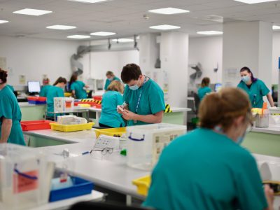NHS workers in face masks at a workstation