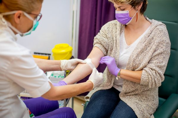NHS workers in face masks having a meeting