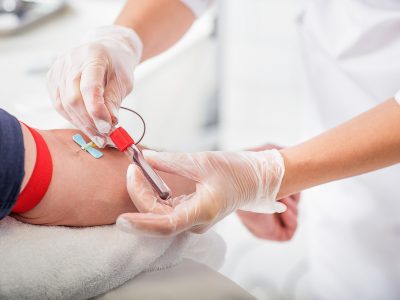 A GP doing a blood test on a patient