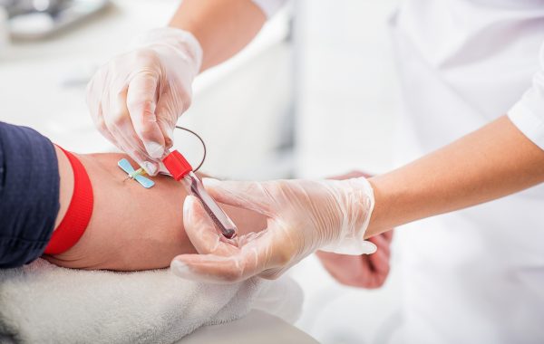 A GP doing a blood test on a patient