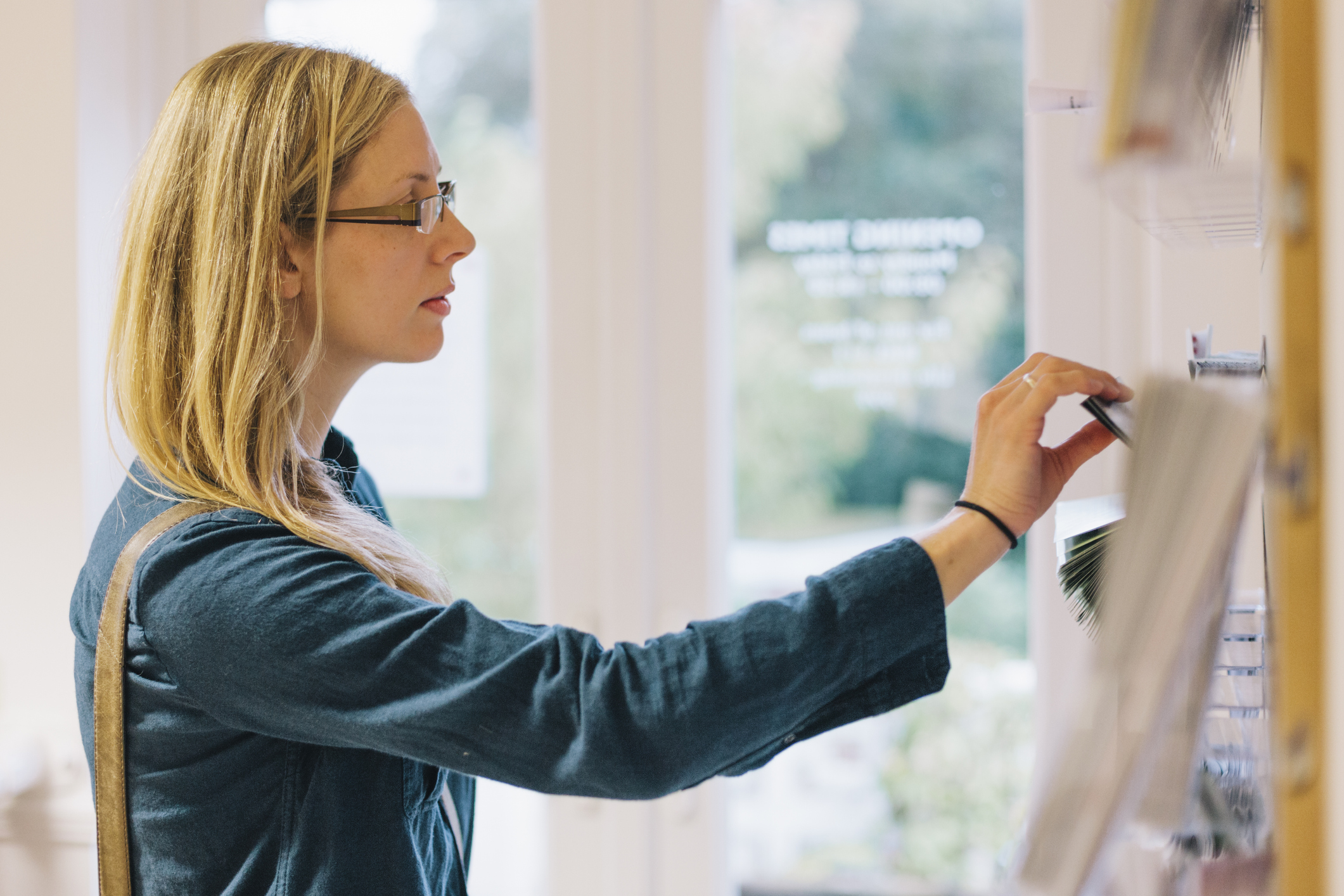 A woman takes a leaflet in a doctor's waiting room