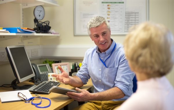 A GP talks to a patient