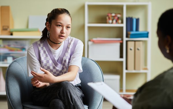 A young person talks to a mental health professional