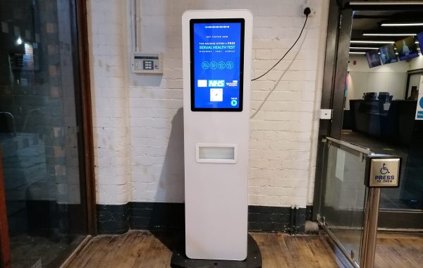 Sexual health test vending machine in the lobby of a venue in central Bristol