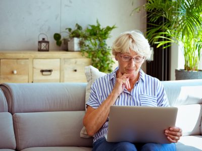 An older woman using a laptop