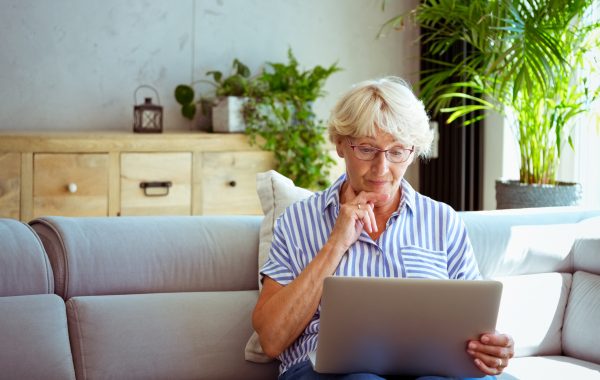 An older woman using a laptop