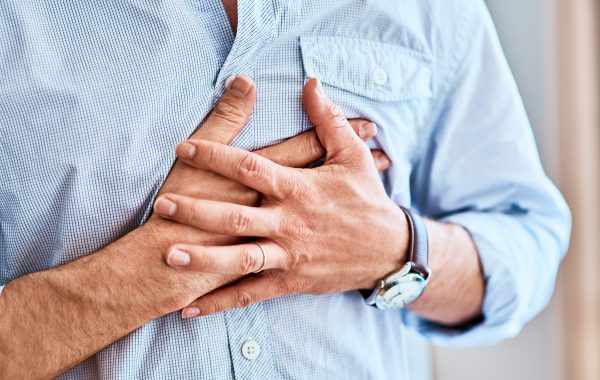 A man clutches his chest