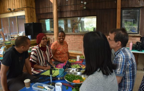 A group of people sitting at a table together sharing food