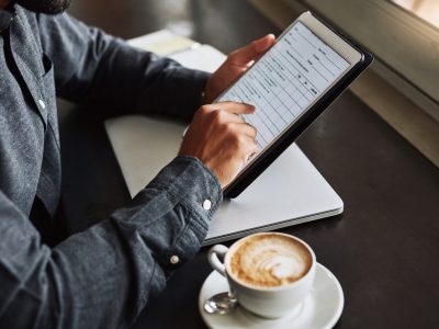 A person fills in an online questionnaire while having their morning coffee