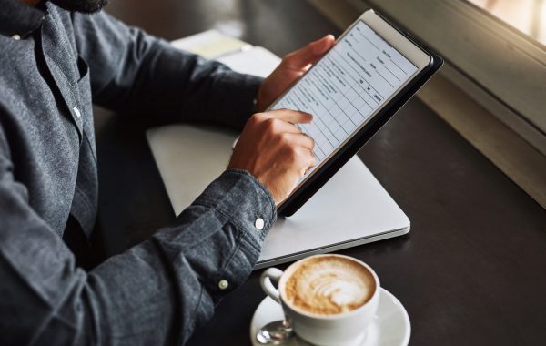 A person fills in an online questionnaire while having their morning coffee