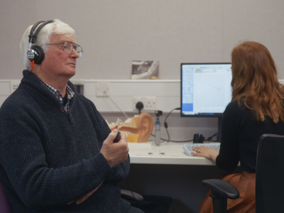 A patient has their hearing tested in a still from the video